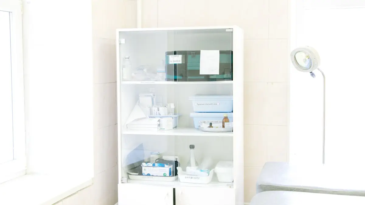 White cabinet stocked with medical instruments and supplies in a bright clinic room, illustrating how to start a med spa
