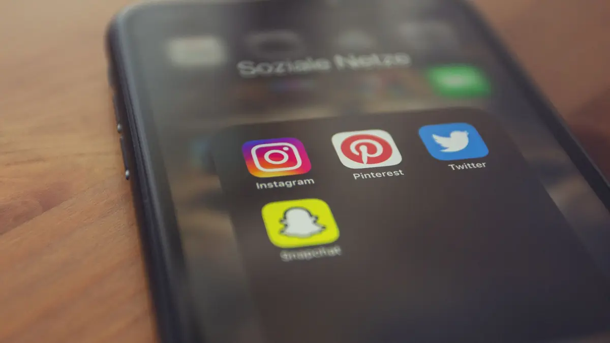 Smartphone displaying popular social media apps like Instagram, Pinterest, Twitter, and Snapchat, illustrating med spa ads