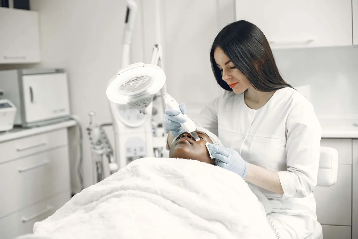 Patient receiving facial treatment at an aesthetic clinic